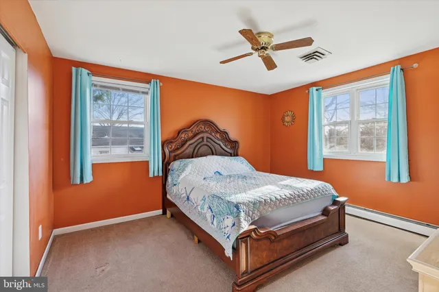 a bed sitting in a room next to a window