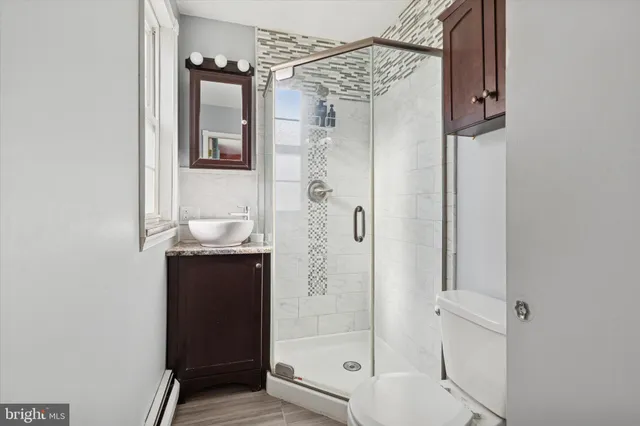 a bathroom with a shower and a sink