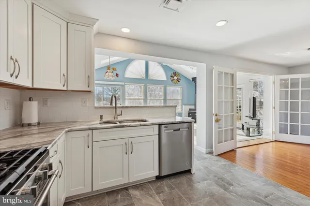 a kitchen with stainless steel appliances granite countertop a stove and a sink
