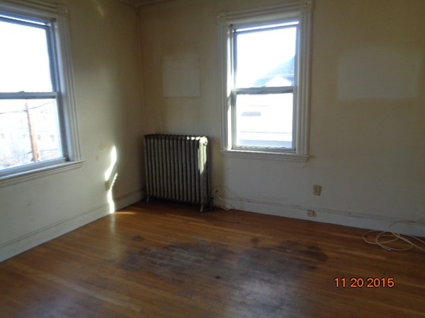 2 Albion Street Salem, MA 01970 - Photo 4 of 10 an empty room with wooden floor and windows