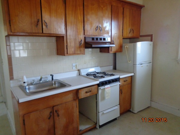 2 Albion Street Salem, MA 01970 - Photo 5 of 10 a kitchen with stainless steel appliances granite countertop a sink stove and refrigerator