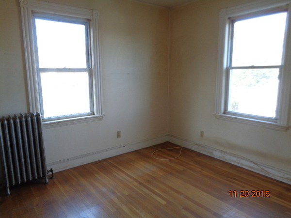 2 Albion Street Salem, MA 01970 - Photo 6 of 10 an empty room with wooden floor and windows