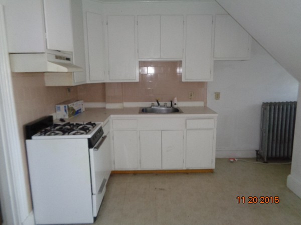2 Albion Street Salem, MA 01970 - Photo 8 of 10 a kitchen with stainless steel appliances granite countertop a sink stove and cabinets