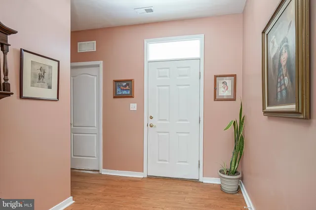 a view of an entryway with wooden floor