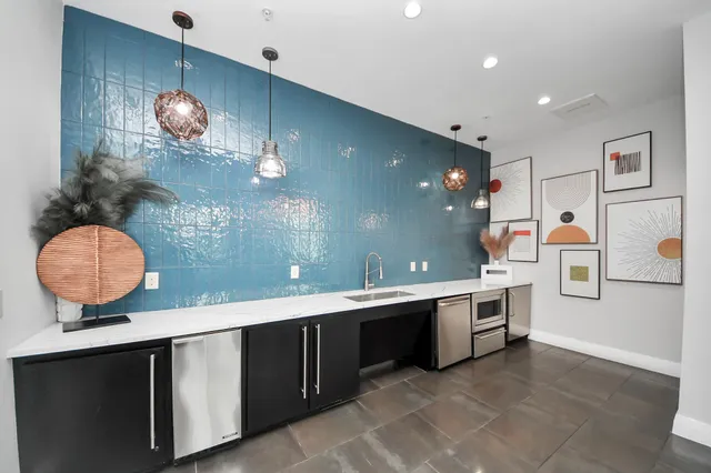 a kitchen with a sink appliances and a counter top space