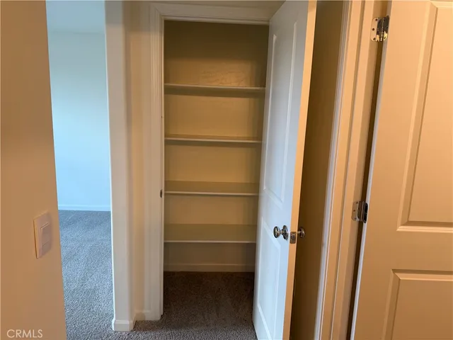 a view of walk in closet with empty racks