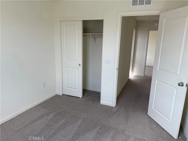 a view of a hallway to rooms