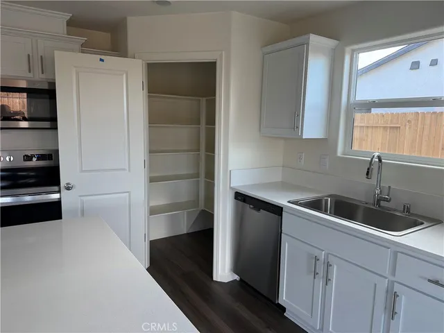 a kitchen with a sink and refrigerator