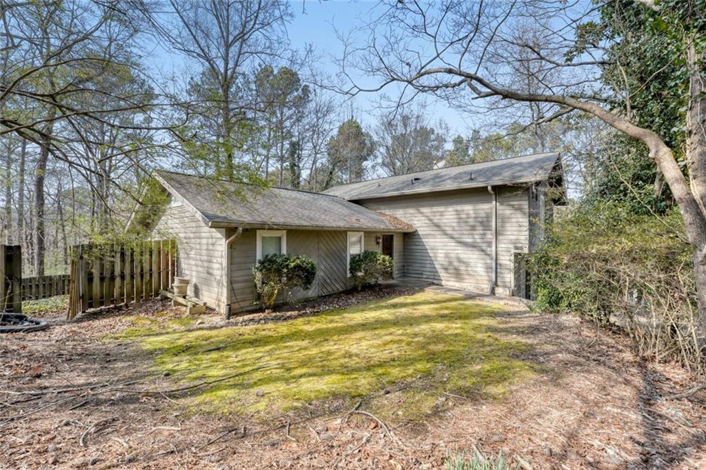 835 Greenvine Trace Roswell, GA 30076 - Photo 2 of 27 a view of a house with a yard covered with snow