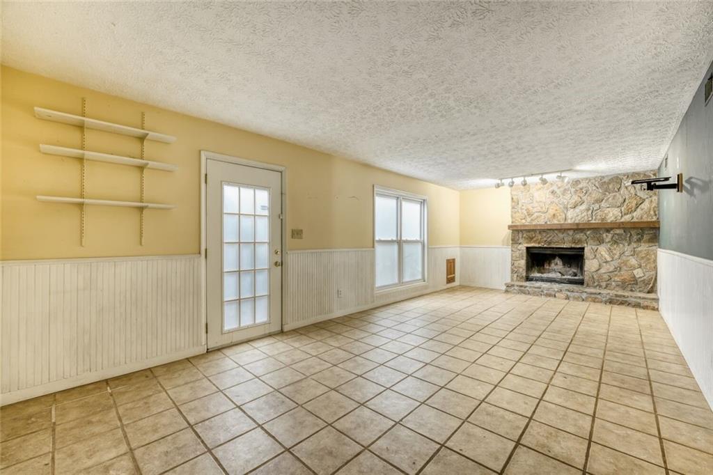 835 Greenvine Trace Roswell, GA 30076 - Photo 21 of 27 an empty room with windows and fireplace