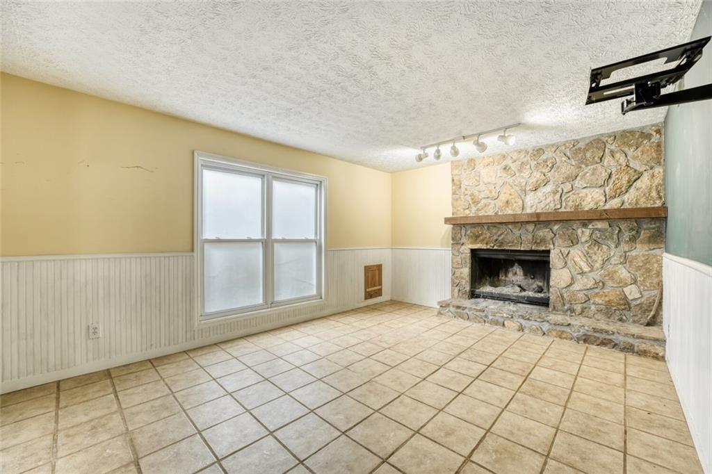 835 Greenvine Trace Roswell, GA 30076 - Photo 23 of 27 a view of an empty room with a fireplace and a window
