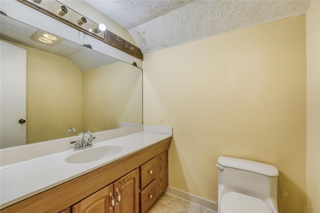 835 Greenvine Trace Roswell, GA 30076 - Photo 24 of 27 a bathroom with a sink and a mirror