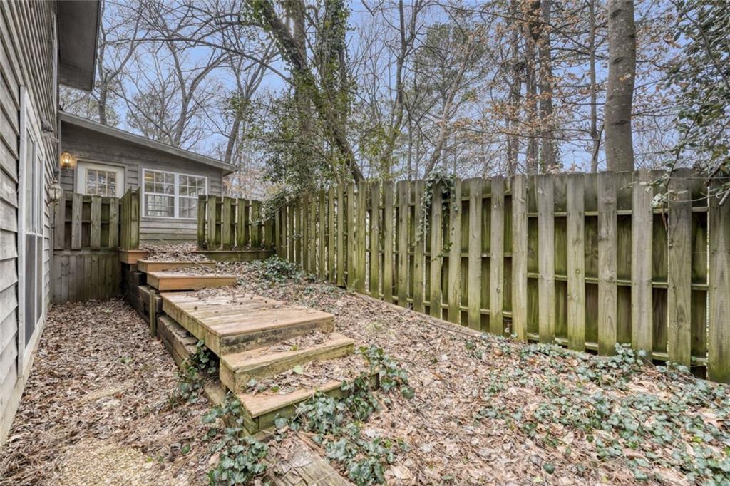 835 Greenvine Trace Roswell, GA 30076 - Photo 26 of 27 a wooden bench sitting in front of a building