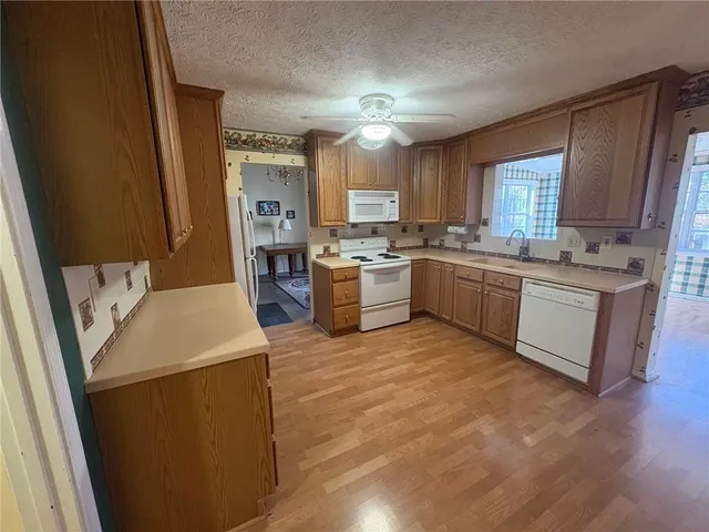 a kitchen with a sink a stove and refrigerator