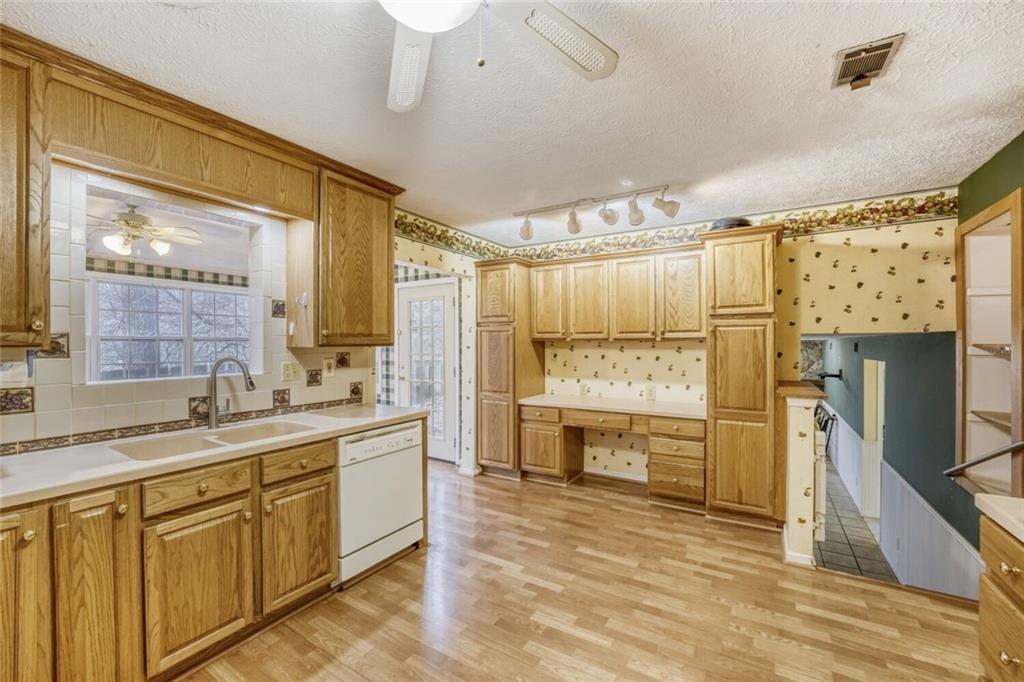 835 Greenvine Trace Roswell, GA 30076 - Photo 4 of 27 a bathroom with a granite countertop sink a toilet a mirror and shower