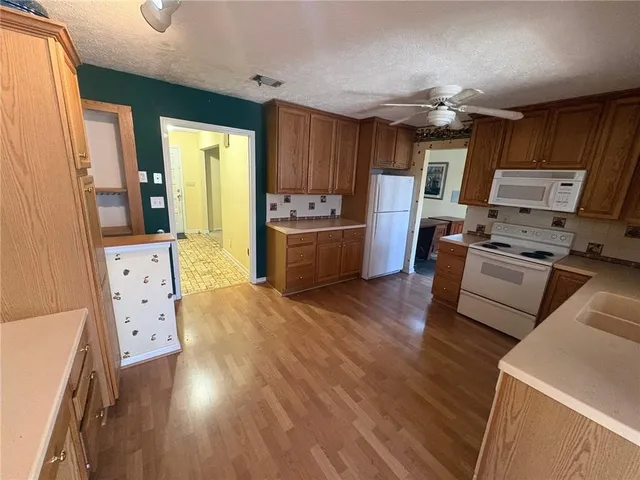 a kitchen with sink refrigerator and stove