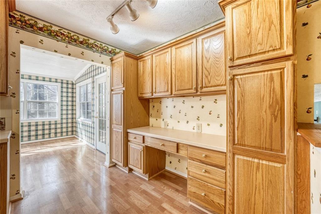 835 Greenvine Trace Roswell, GA 30076 - Photo 7 of 27 a kitchen with granite countertop cabinets a island and appliances