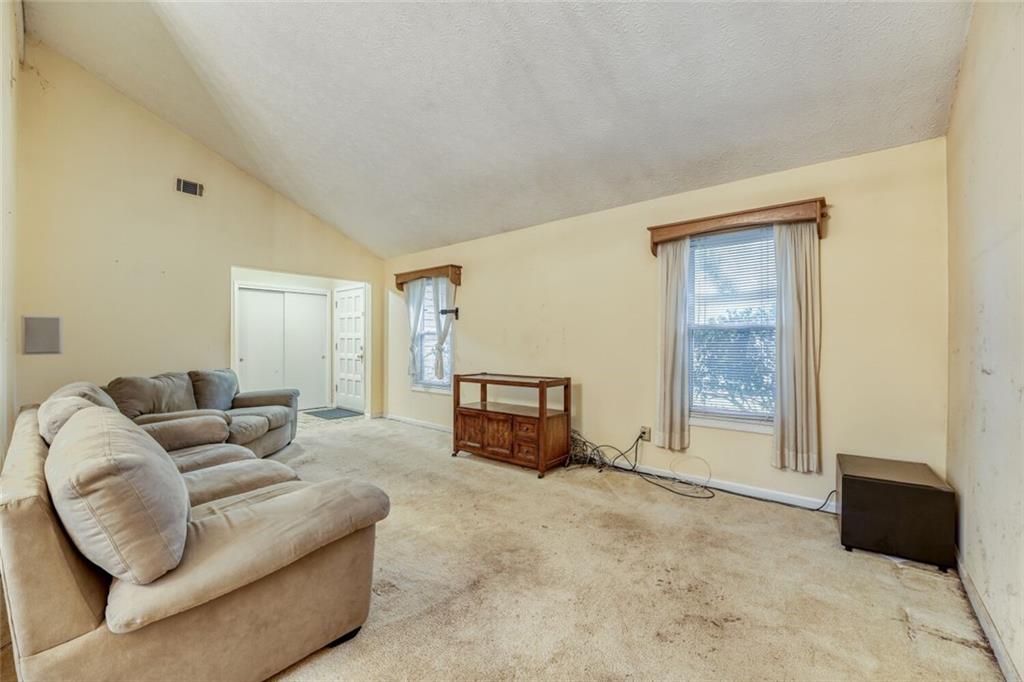 835 Greenvine Trace Roswell, GA 30076 - Photo 9 of 27 a living room with furniture and a window