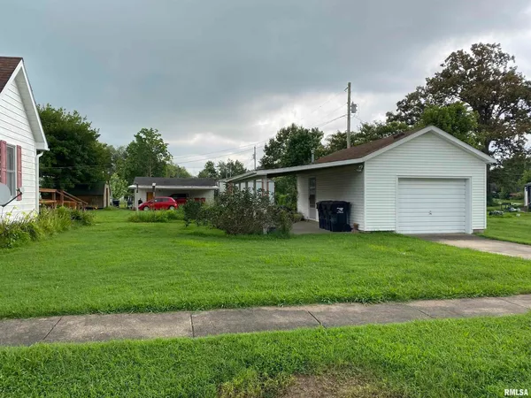 a view of a tiny house with a yard