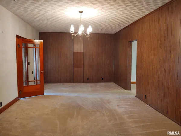 a view of an empty room with a chandelier