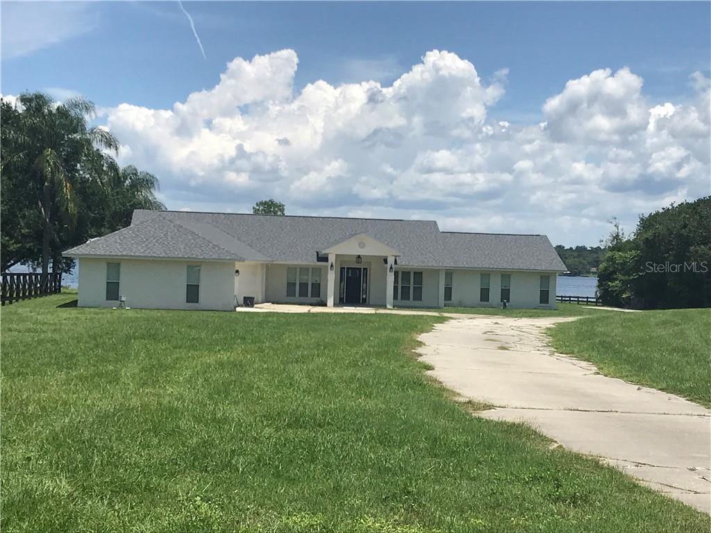 7719 Sadler Road Mount Dora, FL 32757 - Photo 1 of 1 a front view of a house with garden