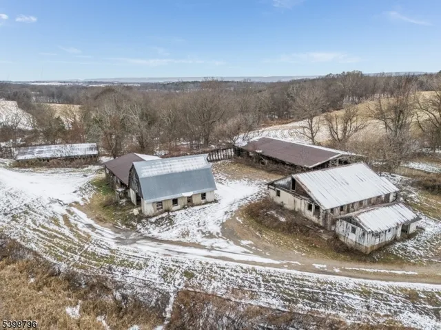 an aerial view of a house with a yard and mountain view in back