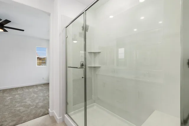 a bathroom with a shower and a glass door