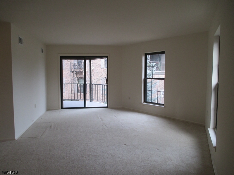 181 Long Hill Road, Unit 6 Little Falls, NJ 07424 - Photo 2 of 20 an empty room with windows