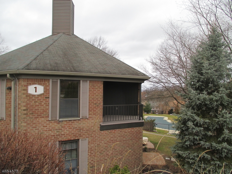 181 Long Hill Road, Unit 6 Little Falls, NJ 07424 - Photo 13 of 20 a front view of a house with a garden