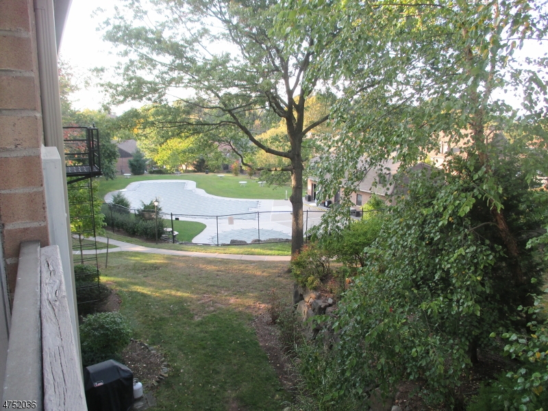 181 Long Hill Road, Unit 6 Little Falls, NJ 07424 - Photo 14 of 20 a view of a yard with plants and large trees