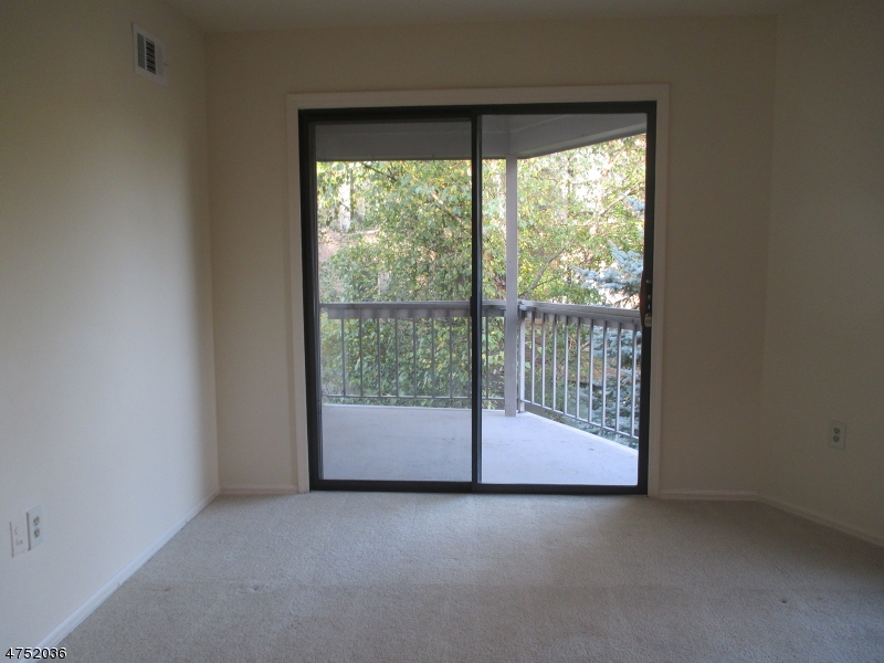 181 Long Hill Road, Unit 6 Little Falls, NJ 07424 - Photo 4 of 20 a view of empty room with floor to ceiling window