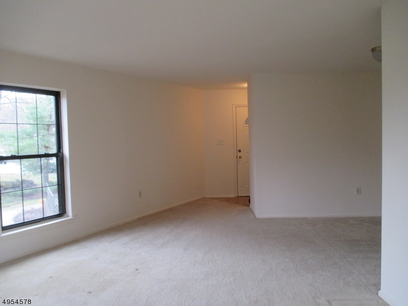 181 Long Hill Road, Unit 6 Little Falls, NJ 07424 - Photo 5 of 20 an empty room with windows