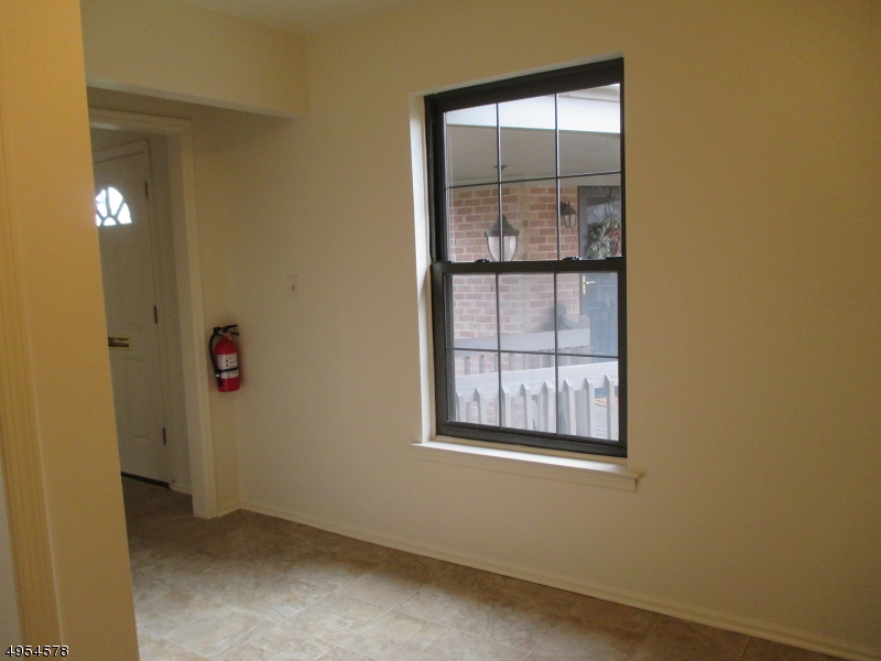 181 Long Hill Road, Unit 6 Little Falls, NJ 07424 - Photo 8 of 20 an empty room with windows