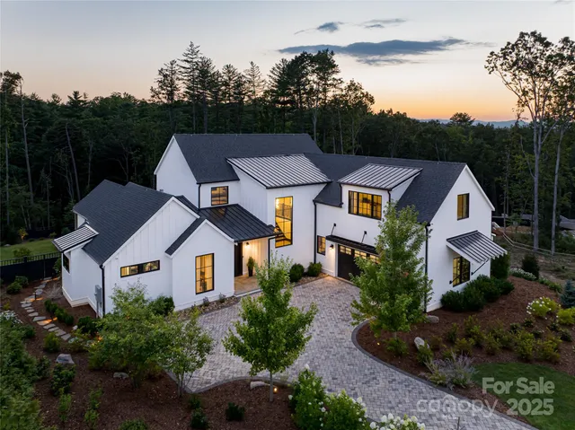 a aerial view of a house next to a yard