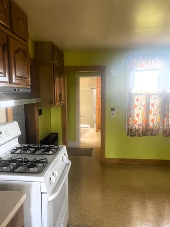 a kitchen with stainless steel appliances granite countertop a stove and a refrigerator with cabinets