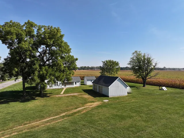 a swimming pool with lots of tress in front of it