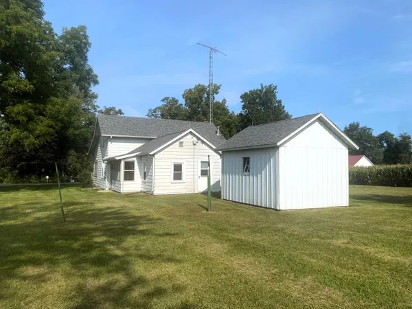 a view of a house with a yard and potted plants