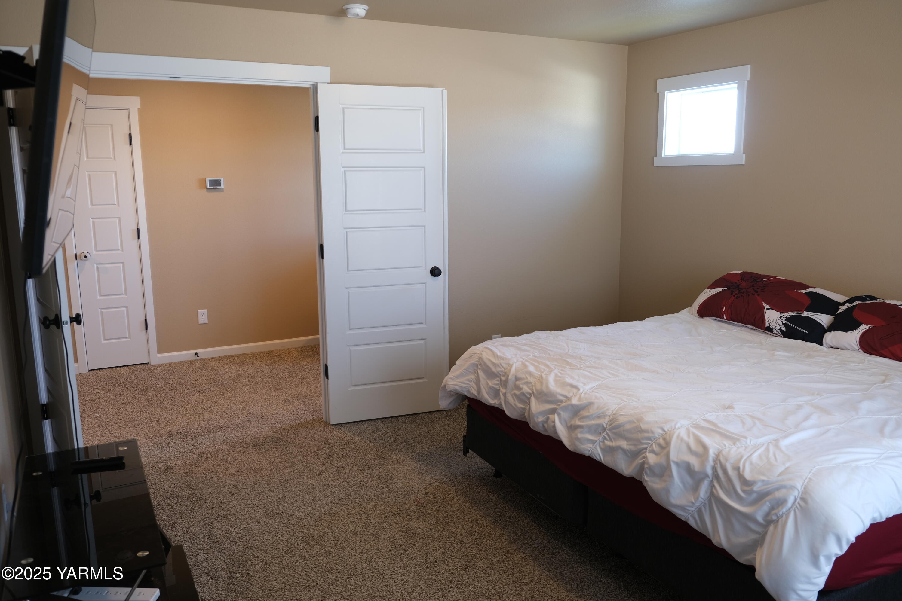 2206 Porter Loop Yakima, WA 98901 - Photo 16 of 34 a bedroom with a bed and a flat tv screen on dresser