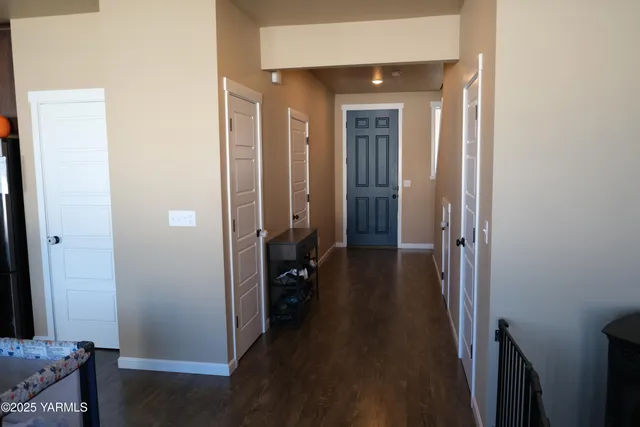 a view of a hallway with a livingroom and a bathroom with sink