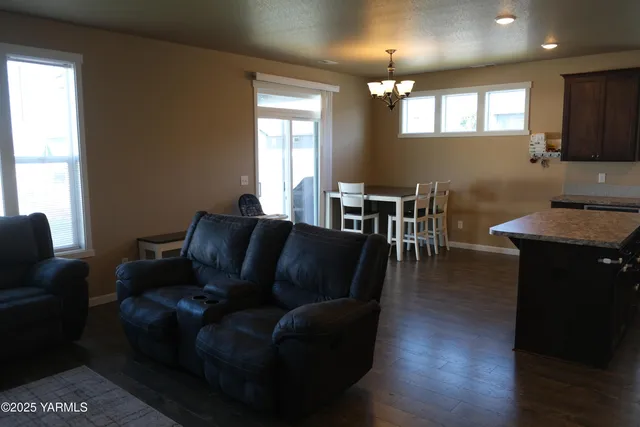a living room with furniture wooden floor and a window