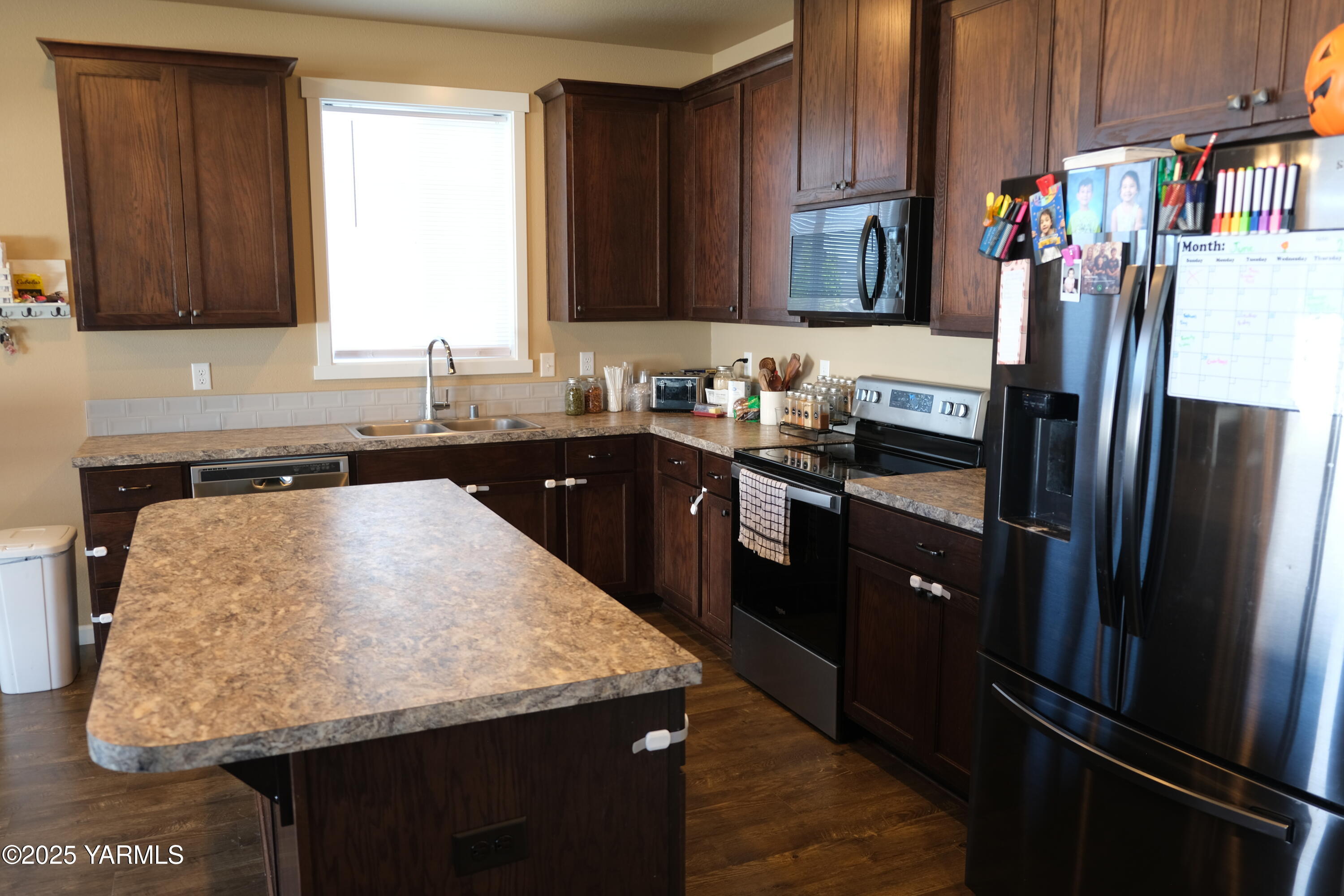 2206 Porter Loop Yakima, WA 98901 - Photo 9 of 34 a kitchen with stainless steel appliances granite countertop a refrigerator and a stove