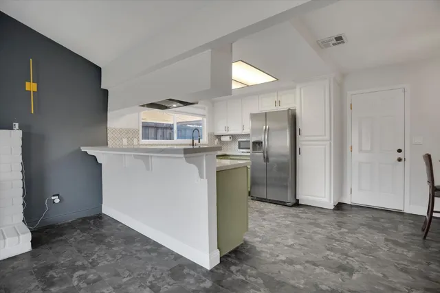 a living room with a bed and a window