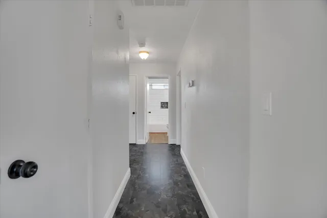a bedroom with a bed and flat screen tv