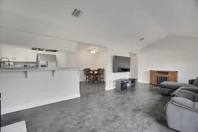 a view of a kitchen with a dining table and chairs