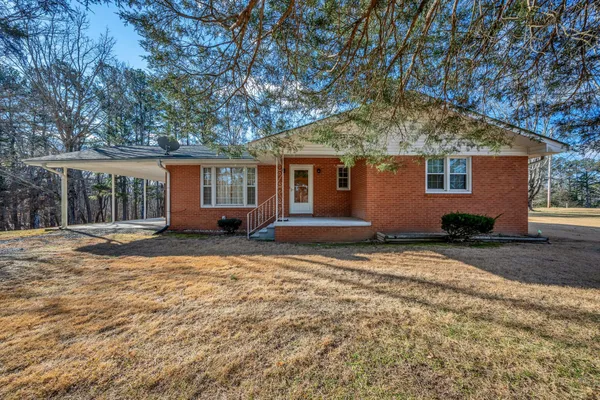 a house that has a tree in front of it