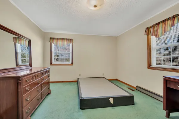a room with window and dresser