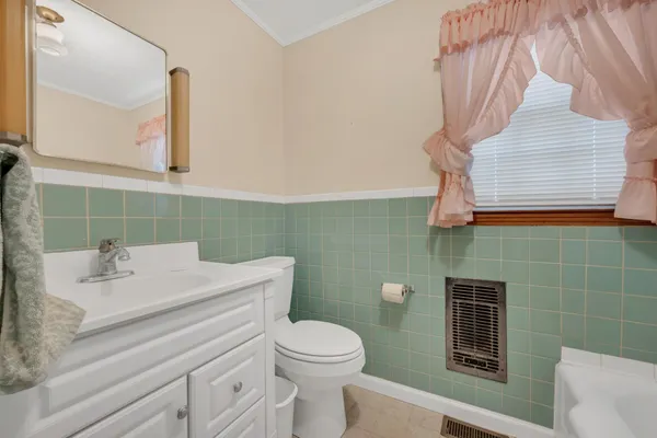 a bathroom with a sink toilet and mirror