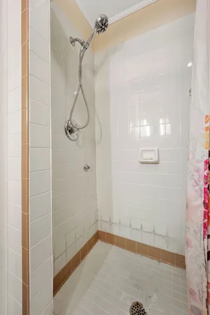 a bathroom with a glass shower door
