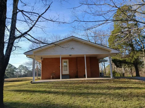 a view of a house with backyard porch and garden