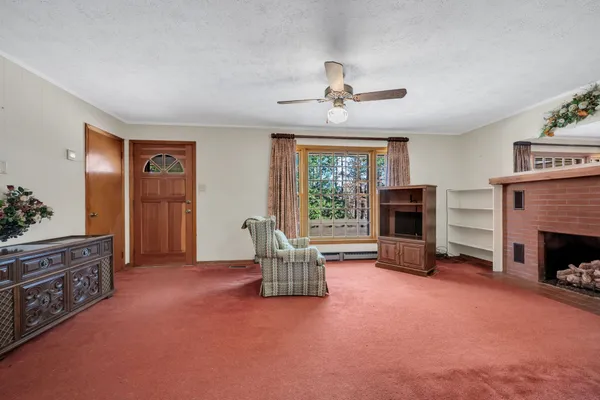 a living room with furniture and a fireplace